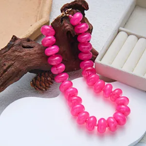 Macro detail of vibrant pink resin beaded necklace with Bohemian style for fashion jewelry
