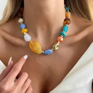 Close-up detail of colorful marbled resin beads and gold accent on a stylish necklace