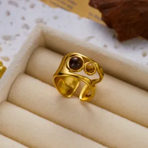Detail view of vintage stainless steel double layer ring with polished tiger eye stones