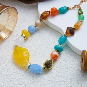 Detailed view of colorful marbled resin beads on a gold-toned necklace for women.