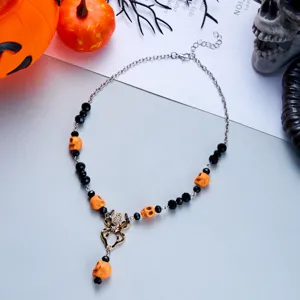 Gothic Halloween necklace with orange skulls and crystal spider pendant detail