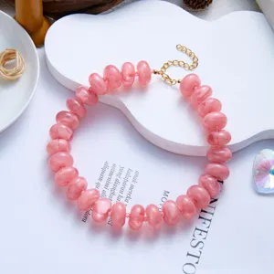 Close-up of pink marbled resin bead necklace with gold-toned extender chain