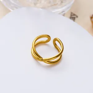 Close-up of a double-layered gold stainless steel ring with vintage open design