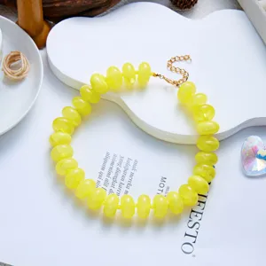 Detailed macro view of vibrant yellow resin beads on a fashionable bohemian necklace