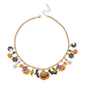 Close-up of golden Halloween necklace with pumpkin, bat, and spider web charms.