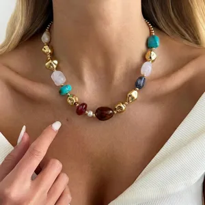 Close-up of a colorful irregular resin bead necklace worn on a model's neck