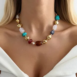 Detailed view of colorful irregular resin bead necklace with metallic gold accents
