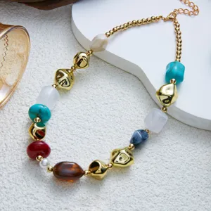 Detailed macro shot of multi-colored marbled resin and gold irregular bead necklace