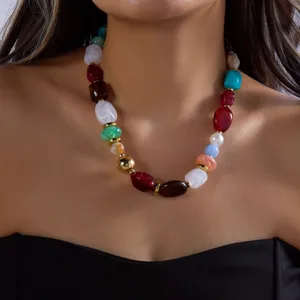 Vibrant multi-colored irregular resin beaded statement necklace shown on model neck