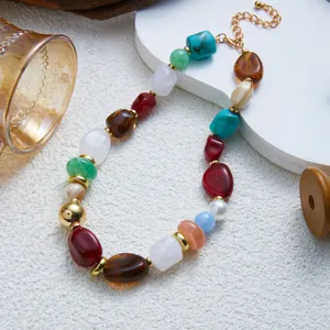 Detailed close-up of a colorful marbled resin beaded necklace with gold-tone hardware