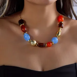 Close-up of a vibrant resin beaded necklace with colorful irregular beads on model