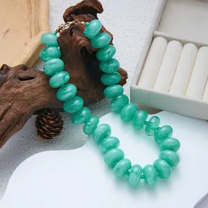 Close-up of green resin beads with marble pattern on a bohemian choker necklace