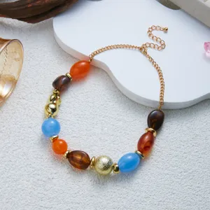 Detailed view of colorful marbled resin bead necklace with gold-toned metal chain and beads