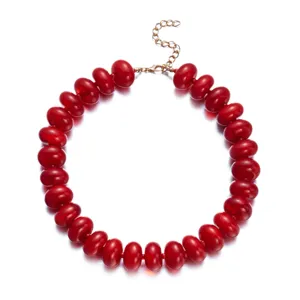 Vibrant bohemian red resin beaded choker necklace featuring a golden adjustable chain.