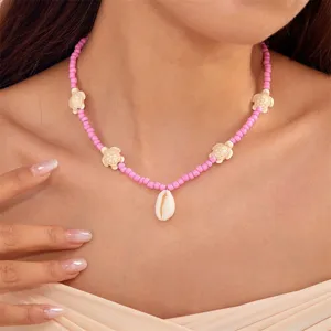 Bohemian pink seed bead necklace with cute turtle charms and cowrie shell pendant for women.