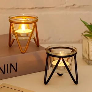 Close-up of modern geometric metal and glass tealight candle holder in home setting.