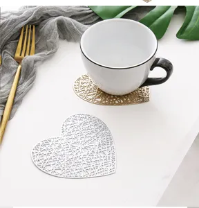 Heart-shaped hollow PVC coaster detail showing exquisite gold and silver finish for home use.