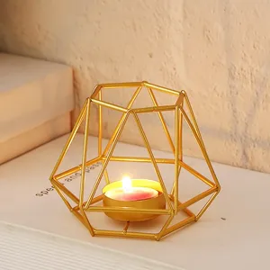 Detailed view of the modern geometric metal candle holder, golden wire design for home decor.