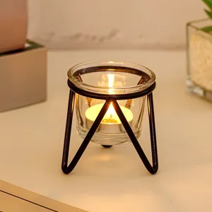 Modern minimalist metal candle holder with glass cup and tea light for home decor detail.