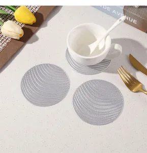 Silver hollow PVC coaster detail view, heat resistant table mat, modern minimalist decor style.