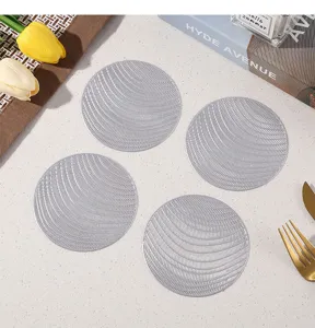 Close-up detail of hollow round silver PVC coasters showcasing stylish textured tabletop decor.