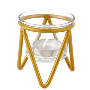 Modern minimalist geometric gold metal candle holder with glass cup for home decor and wedding.