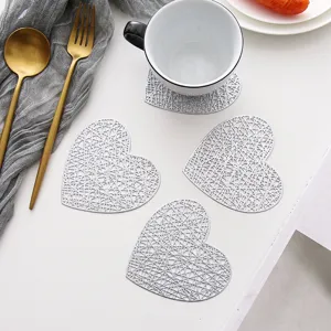 Silver heart-shaped hollow PVC coasters, heat insulation coffee cup mats for home table decor.