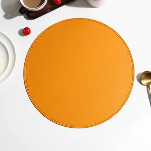 Round orange leather placemat with fine stitching, waterproof heat-insulation table mat.