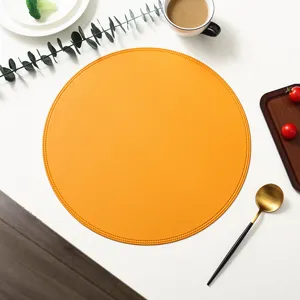Round leather placemat detail, orange waterproof oil-proof table mat for dining table.