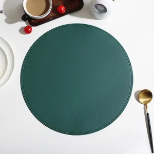 Round leather placemat for dining table, waterproof and heat-resistant table mat style.