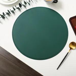 Round green leather placemat detail view, waterproof, heat-insulating and stylish decor.