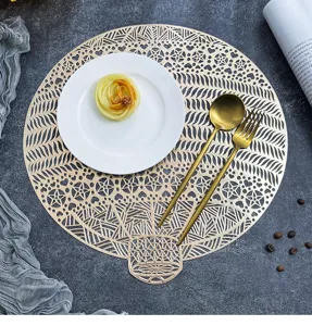 Detailed view of Nordic hollow PVC bronzing western placemat, washable heat insulation table mat.