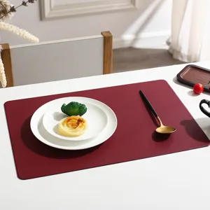 Close-up detail of a rectangular solid color leather placemat for modern table decor.