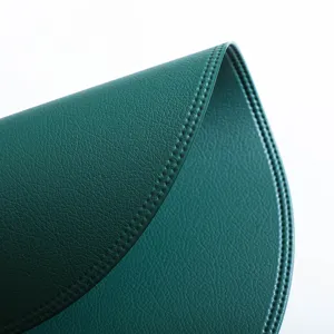 Round leather placemat detail view, waterproof and heat-resistant dark green table mat.