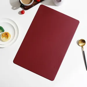 European minimalist solid color leather rectangular placemat detail view showing fine texture.