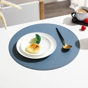 Detail view of a stylish round blue leather placemat, waterproof and heat-insulating.