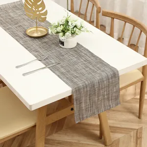 Detailed view of modern minimalist fabric table runner with textured woven design for home dining decor.
