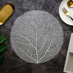 Tovaglietta rotonda in PVC traforato con motivo di rami di corallo, tappetino termico nordico.