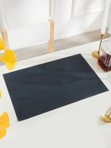 Dark blue woven PVC placemat, heat-resistant table mat for modern dining room decor.