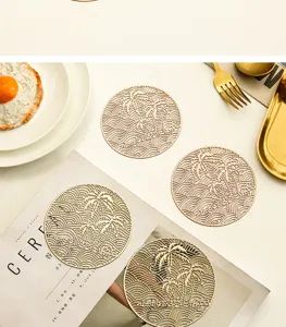 Nordic hollow round PVC placemat gold heat resistant table mat stylish dining decor.