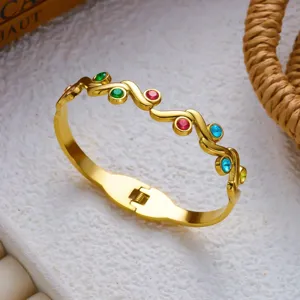 Detailweergave van een gouden roestvrijstalen armband met kleurrijke kristallen.