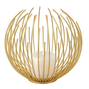Modern gold wire metal candle holder with white pillar candle for home decor and wedding props.