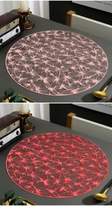 Vista ravvicinata dettagliata della tovaglietta rotonda in PVC cavo con elegante motivo floreale.