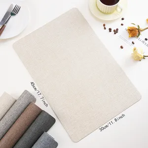 Close-up of the PU leather placemat showing fine woven texture and elegant table setup.