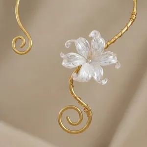Close-up of elegant white lily flower detail on a vintage gold-toned open choker necklace