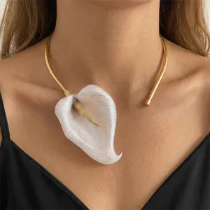 Detailed macro view of French vintage white Calla Lily floral pendant on gold choker