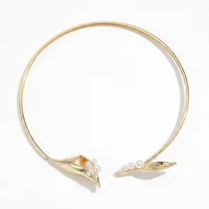 Close-up of elegant gold calla lily choker necklace with pearl accents in minimalist style