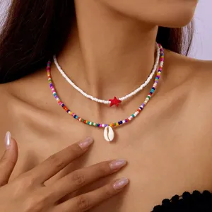 Bohemian layered necklace set with colorful seed beads, cowrie shell, and red star pendant