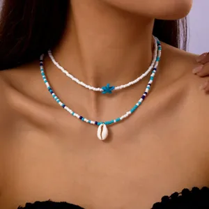 Bohemian layered seed bead necklace set with white cowrie shell and blue starfish