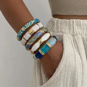 Detailansicht von Vintage Emaille-Armreifen in Blau und Weiß mit Goldakzenten